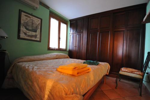 a bedroom with a bed with an orange robe on it at B&B Casa Armonia in Pizzo