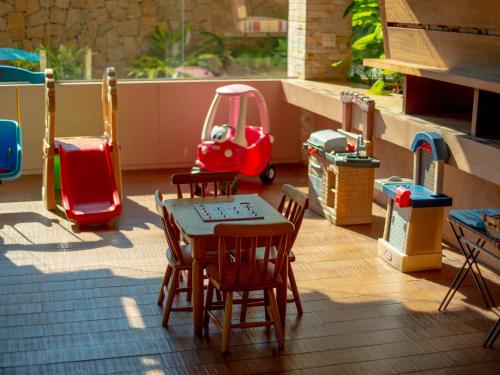a toy patio with a table and chairs and a toy car at Hotel Real Villa Bella in Ilhabela
