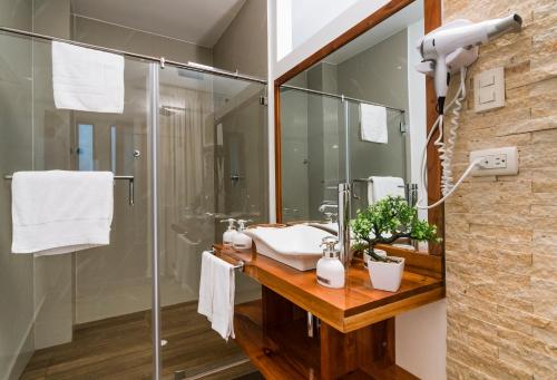 a bathroom with a sink and a shower at Hotel La Isla in Puerto Ayora