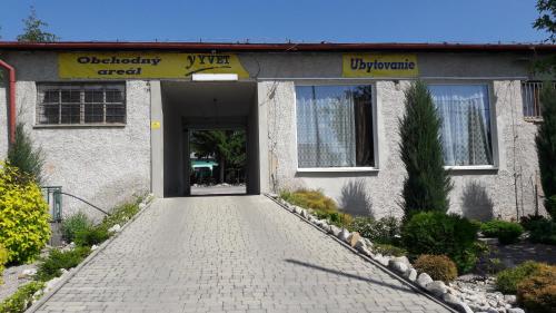 a building with a walkway in front of it at Apartman YVET in Sučany