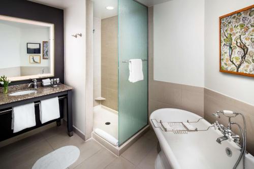 a bathroom with a tub and a shower and a sink at Andaz Savannah - A Concept by Hyatt in Savannah