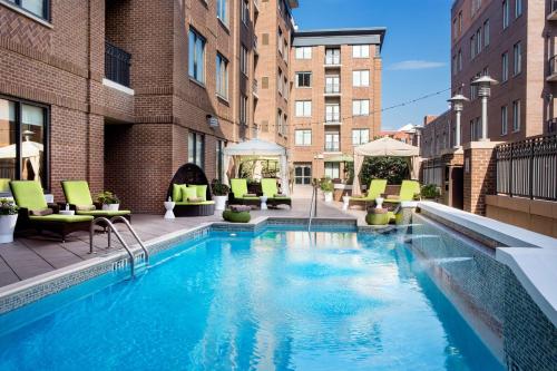 a large swimming pool with chairs and a building at Andaz Savannah - A Concept by Hyatt in Savannah