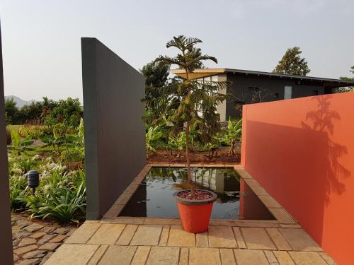 a garden with a pond in front of a house at Beyond by Sula in Nashik