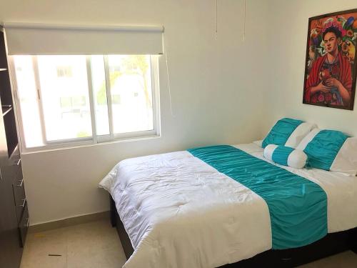 a bedroom with a large bed with a window at Casa acogedora Rivera Maya in Playa del Carmen