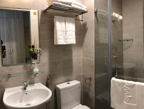 a bathroom with a toilet and a sink and a shower at La Cigale Residence in Ho Chi Minh City