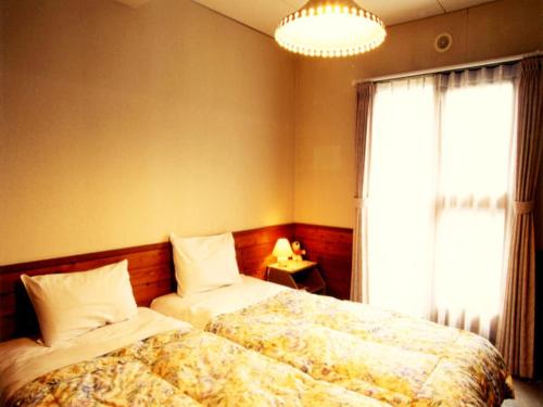 Tempat tidur dalam kamar di Pension Newman
