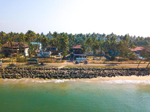 a beach with a bunch of rocks in the water at Sapphire Club Cherai Beach Villa in Cherai Beach