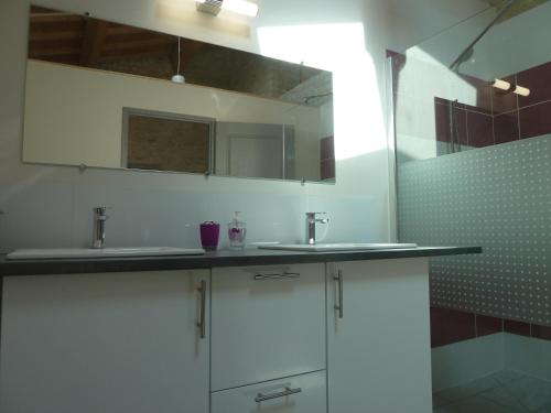 a white bathroom with two sinks and a shower at LES 3 PETITS COCHONS in Le Bouchet