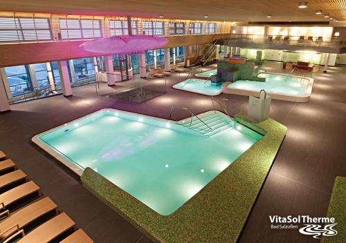 a large indoor swimming pool in a building at Hotel Stadt Hamburg in Bad Salzuflen