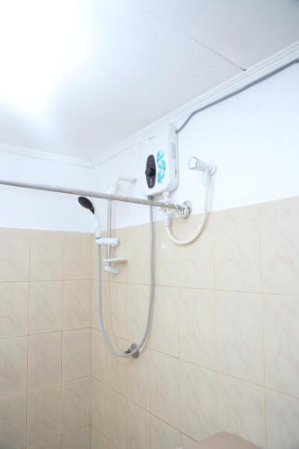 a shower in a bathroom with a shower head at Holiday Home Bentota in Bentota