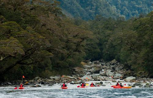 a group of people in kayaks on a river at Bella Vista Motel Te Anau in Te Anau