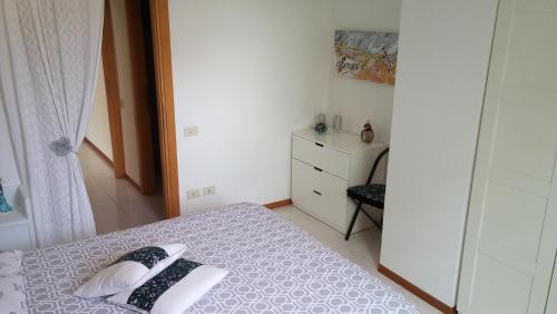 a small bedroom with a bed and a dresser at Il risveglio sul Giano in Fabriano