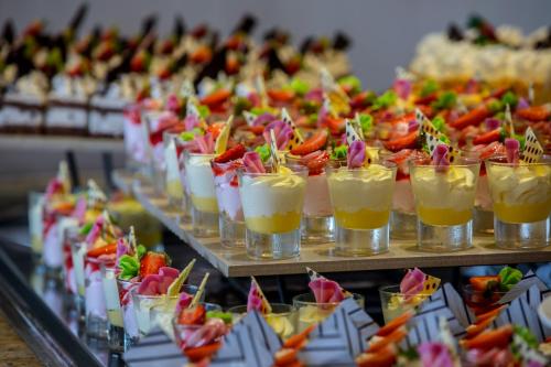 a row of glasses filled with fruit and cocktails at Leonardo Cypria Bay in Paphos City
