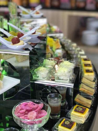 a buffet line with different types of food on it at favehotel PGC Cililitan in Jakarta