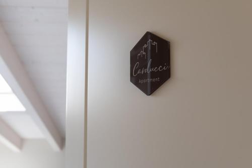 an open door with a sign that reads all confidence next to it at San Lorenzo Apartments in Sirmione