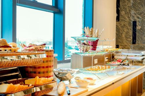 a buffet with bread and pastries on a table at Muong Thanh Luxury Vientiane Hotel in Vientiane