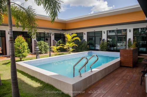 a swimming pool in front of a house at Shafa Resort in Mae Sot
