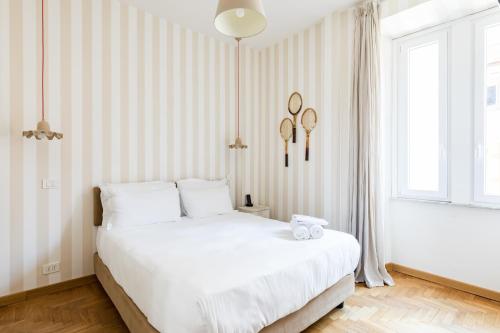 a bedroom with a white bed and a window at Salotto Monti in Rome