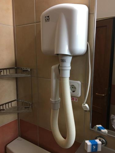 a white phone in a bathroom next to a toilet at Motel Sora in Sovata