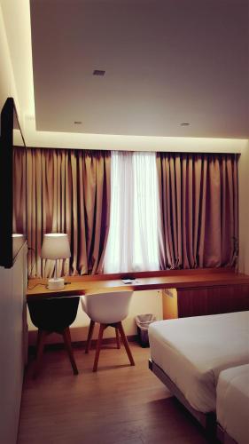 a bedroom with a desk and a bed and a window at Dorian Inn - Sure Hotel Collection by Best Western in Athens