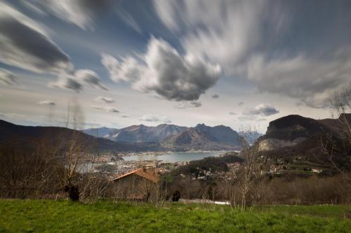 a view of a town and a lake with mountains at Hotel Locanda Mel in Calolziocorte
