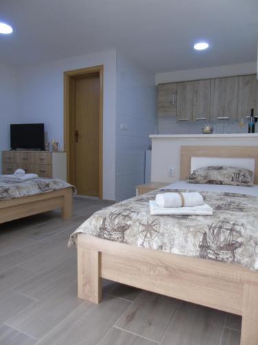 a bedroom with two beds with towels on them at Apartments Marysol in Kotor