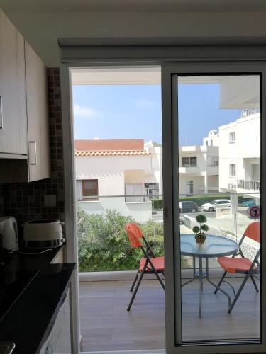 a kitchen with a sliding glass door leading to a patio at Chicos Studios in Ayia Napa