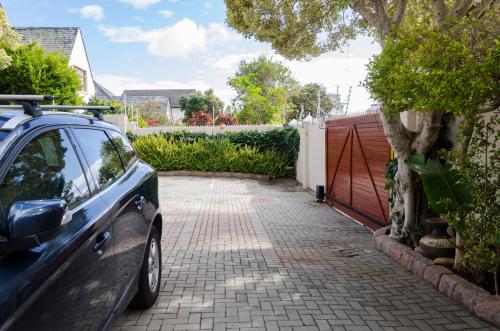 a car parked in a driveway next to a fence at Brighton Lodge - #Solar Energy #No Loadshedding in Port Elizabeth