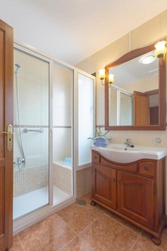 a bathroom with a shower and a sink and a mirror at Villa Bella Lucia Luxury 2 in Corralejo