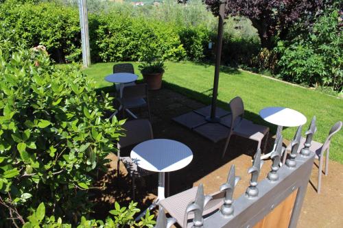 a group of tables and chairs in a garden at Ellebì B&B in Montone