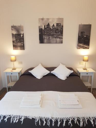 a bedroom with a bed with two side tables at Casa Oliver in Lucca