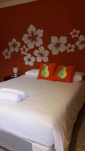a bedroom with a bed with flowers on the wall at Chill land house in Bang Tao Beach