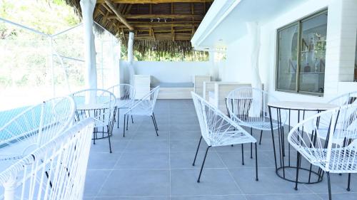 a group of tables and chairs on a patio at Hidden Palms in Nosara