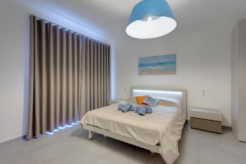 a bedroom with a bed and a large window at Seafront Apartment Sliema in Sliema