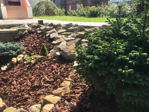 a garden with rocks and plants in a yard at DNM Inn in Koryčany