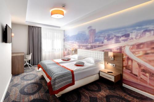 a hotel room with a bed and a painting on the wall at Plaza35 in Sibiu