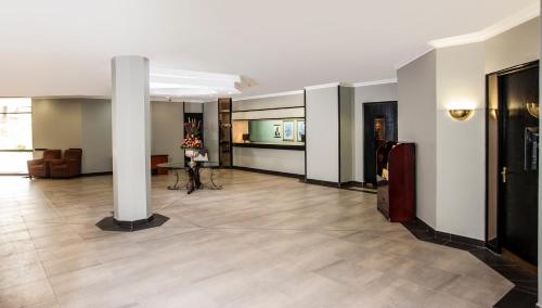 an empty lobby with a column in a building at Avani Maseru Hotel in Maseru