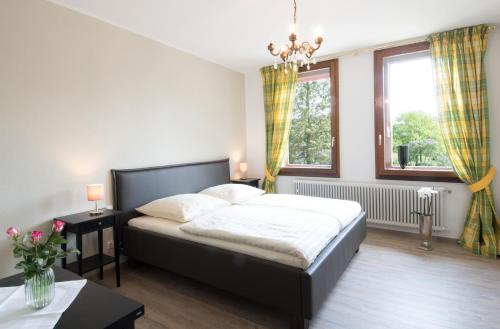 a bedroom with a large bed and a window at Altes Forsthaus in Manderscheid