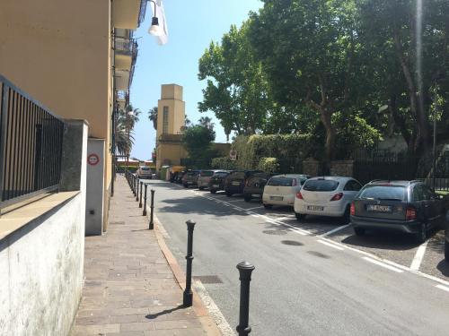 a street with cars parked on the side of the road at Una finestra sul mare in Cogoleto