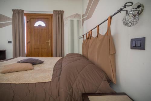 a bedroom with a bed and a door at La Casa Del Grillo 1 in Aosta