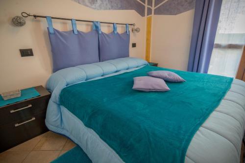 a bedroom with a large bed with two pillows on it at La Casa Del Grillo 1 in Aosta