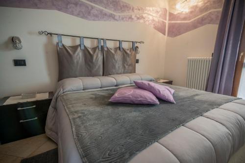 a bedroom with a bed with two pillows on it at La Casa Del Grillo 1 in Aosta