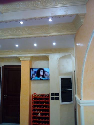 a tv on a wall in a room with wine racks at B&B DA DILETTA in Rieti