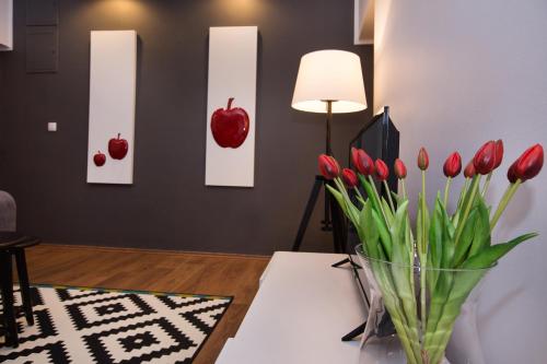 a vase of red tulips on a table in a living room at Apartment Toni Relax in Split