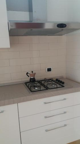 a kitchen with a stove with a tea pot on it at Vient e mare (Sea wind) in Torre Annunziata