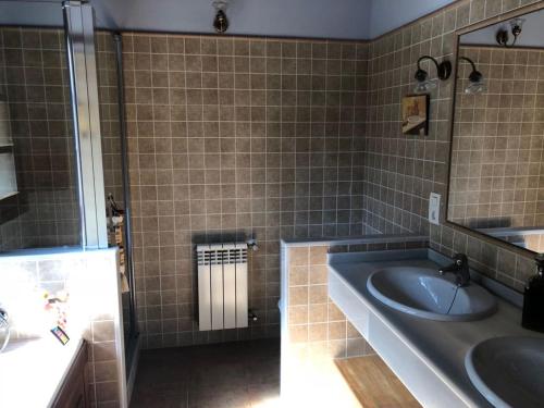 a bathroom with a tub and a sink and a mirror at Lugar Meluerda in Meluerda