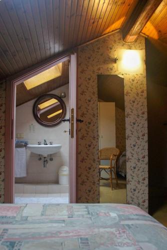 a bedroom with a bathroom with a sink and a bed at Hotel Locanda Mel in Calolziocorte
