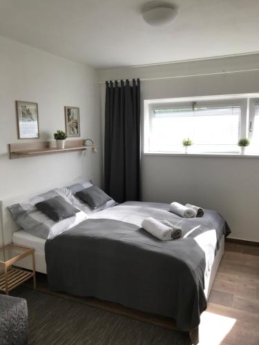 a bedroom with a large bed with two towels on it at Pension SALMA in Český Krumlov