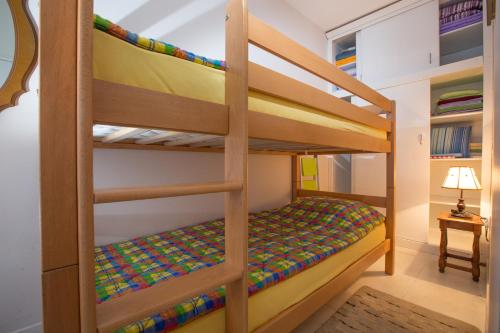 a bunk bedded room with a bunk bed in a house at Valentina Apartman in Petrovac na Moru