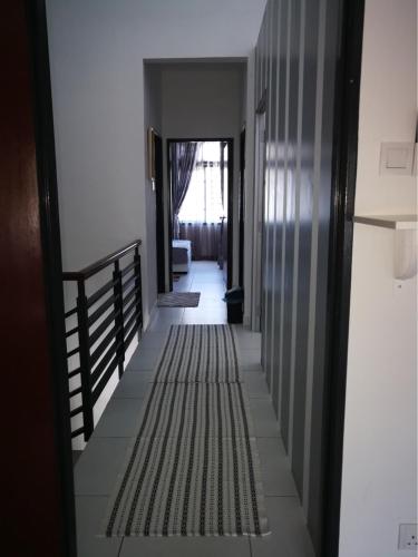 a hallway leading to a room with a hallway at Arianna Homestay in Pasir Gudang